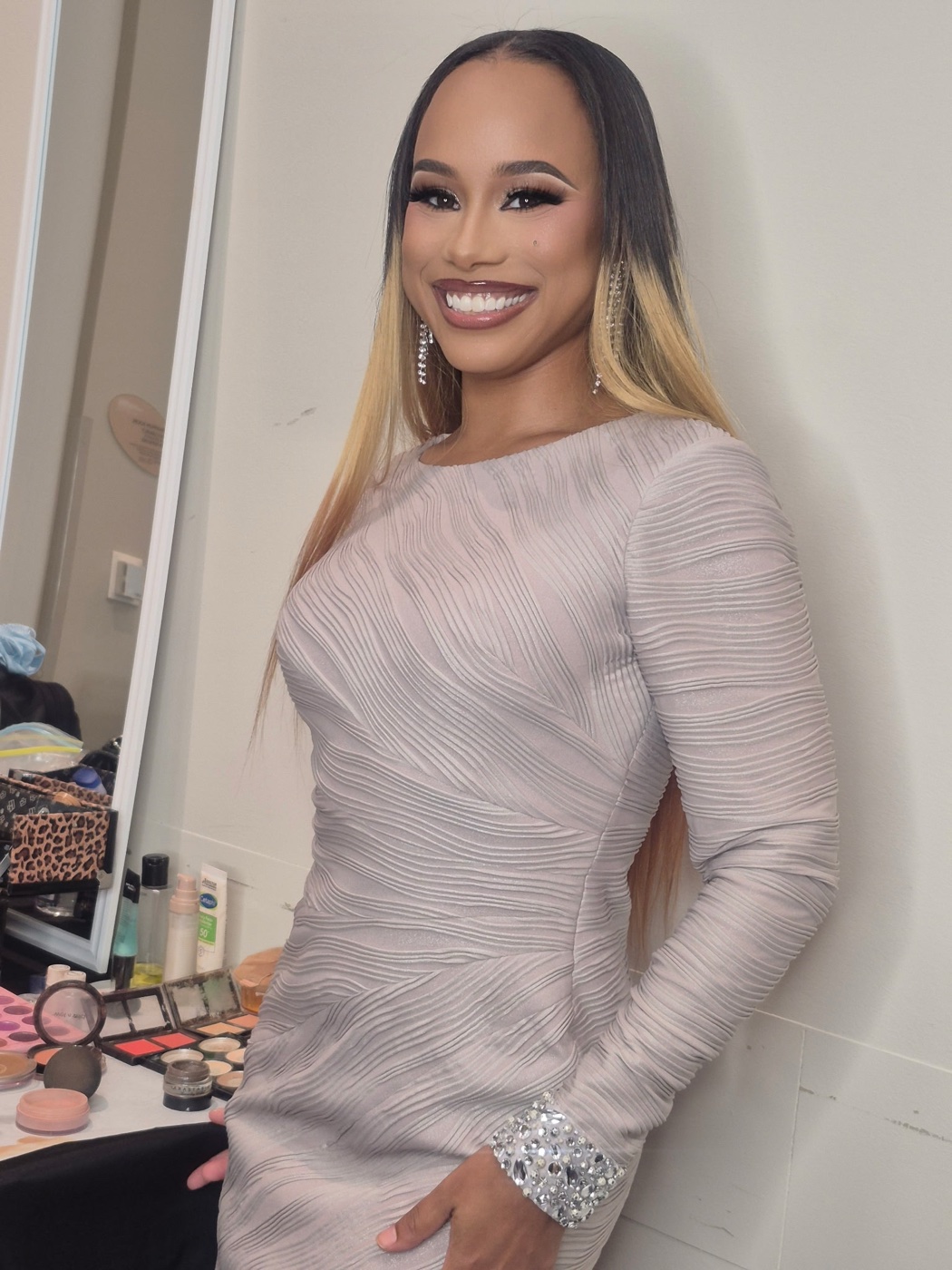 Jada Nicole Howard, smiling backstage in a champagne dress